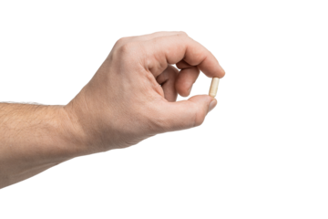 Male hand holding white medicine capsule, antibiotic pill, or painkiller, isolated on transparent background. healthcare and treatment concept