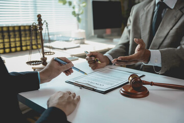 Lawyers discussing contract details and legal advice in courtroom with gavel and scale of justice