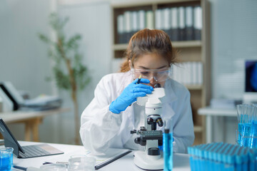 Scientist using microscope analyzing sample in modern laboratory
