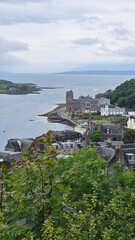 Fototapeta premium Panoramic top view of the fisherman village with fishing boats and house roof at the pier. Scotland