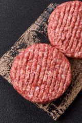 Fresh raw ground beef burger patty with salt and spices