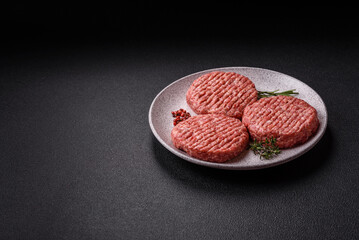 Fresh raw ground beef burger patty with salt and spices