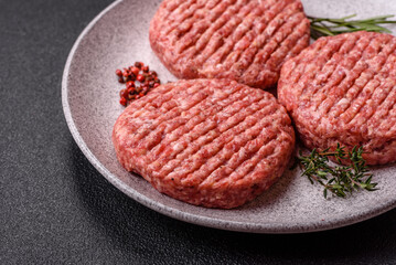 Fresh raw ground beef burger patty with salt and spices