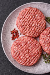 Fresh raw ground beef burger patty with salt and spices