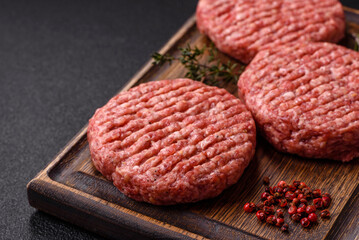 Fresh raw ground beef burger patty with salt and spices