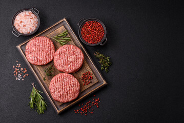 Fresh raw ground beef burger patty with salt and spices