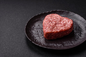 Raw beef or pork burger patty in the shape of a heart