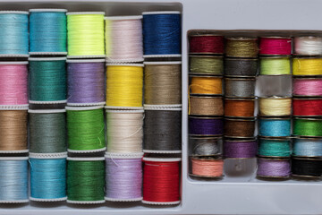 background of coils with multicolored sewing threads