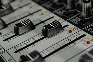 Photograph of faders analog mixer analog mixer dj professional sound mixing. Concept: Technology,...