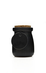 Scented candle in closed black glass jar and blank tag isolated on white background