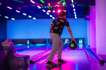 happy young boy child have fun cheering while playing bowling game bowling alley