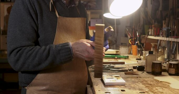 master violin maker at work in his workshop in Cremona Italy