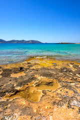 Ano Koufonisi beach with rocks and azure sea water. Small Cyclades, Greece