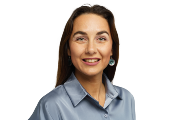 Woman smiling warmly in a light blue blouse with elegant earrings against a plain white background