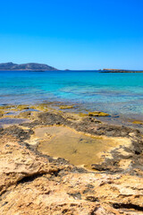 Ano Koufonisi beach with rocks and azure sea water. Small Cyclades, Greece