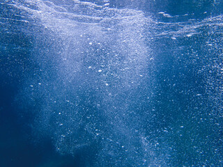 Air bubbles underwater rising to water surface, natural scene, bubbles under water, bubble undersea, sea in crystal clear green water. Real image very suitable for backgrounds, Great for background.