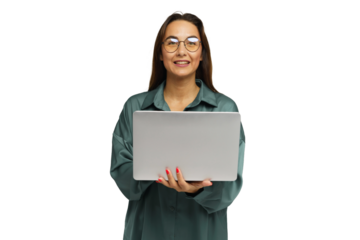 Smiling woman holds laptop in a professional setting while wearing a casual outfit