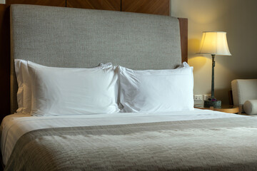 table lamp on bedside with white bedding in the bedroom