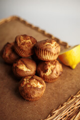 Muffins with lemon lay at wooden table