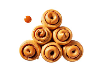 Fototapeta premium Overhead shot of six golden-brown sweet rolls arranged in a triangle with a caramel drop Ideal for food blogs recipe websites or packaging