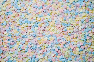 Obraz premium Background of small pastel colored candy hearts for Valentine's Day