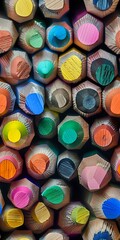 Colorful macro view of pencil ends arranged in a tight pattern, showcasing vibrant tips in yellow, blue, pink, green, and orange hues. Perfect for education, creativity, or artistic design backgrounds