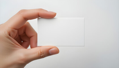 Fototapeta premium Elegant Blank Business Card Held in Hand with Copy Space for Corporate Branding