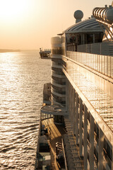 Cruise ship sails on the Elbe into the sunset and towards the open sea.