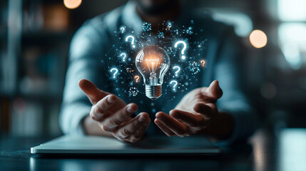 Glowing Lightbulb With Question Marks Held In Hands