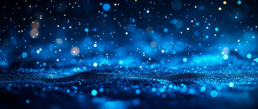 Vibrant dark blue glittering background with bokeh lights