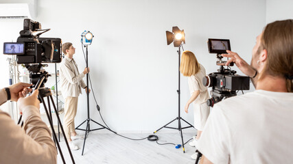 Studio lighting technician. Photograph lamp. Media team prepares filming equipment for work....