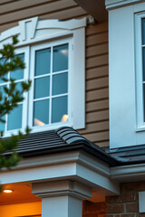 Fototapeta premium Elegant Home Exterior: Modern Architecture and Classic Design. Discover the beauty of this house's architecture, from its stylish windows to its charming porch and brick details.