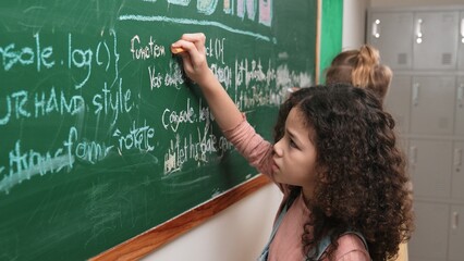 American student studying coding engineering prompt while writing answer on blackboard....