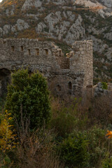Fototapeta premium Vertical shot of ancient stone arches and medieval walls inside Haj-Nehaj fortress, mysterious ruins on a mountain peak, Montenegro travel aesthetic