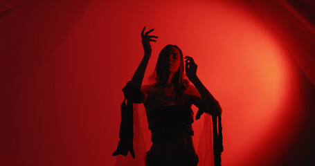 Spiritual dance. Soul healing. Relaxed woman silhouette in trance wearing polyethylene rags...