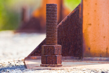 Weathered and decaying metal framework with rust-encrusted bolts
