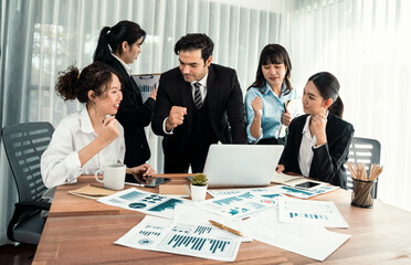 Diverse group of business analyst team analyzing financial data report paper on office table. Chart and graph dashboard by business intelligence analysis for strategic marketing planning Habiliment