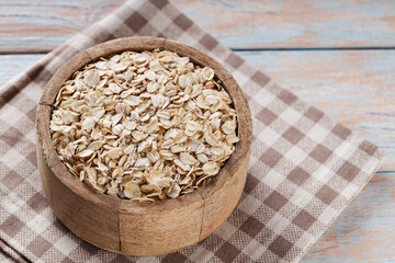 Raw Rolled Oats in Wooden Bowl, Healthy Eating Concept, Copy Space