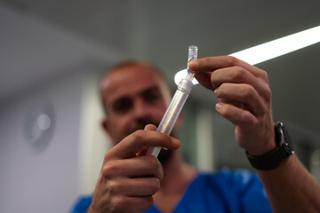 hospital ICU nurse with a syringe loading medication