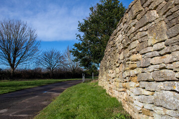 old stone wall and tree , old stone fence in England