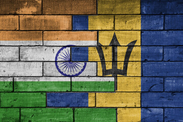 colourful painted big flag of india and flag of barbados on a massive old brick wall background....