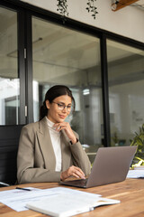 Vertical portrait middle eastern woman using computer technology app for work online.Focused...