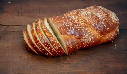 Easter sweet bread, homemade tsoureki braid on wooden table, closeup