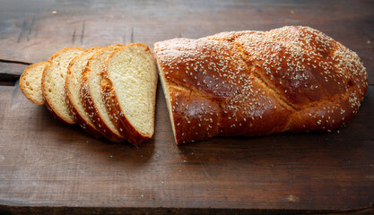 Easter sweet bread, homemade tsoureki braid on wooden table, closeup