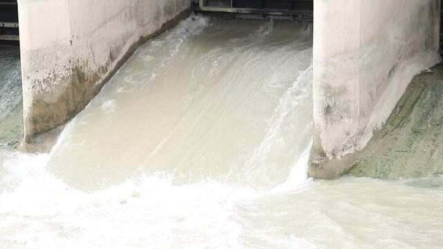 Beautiful View of water rushing Video. Indus River Head Taunsa Barrage Gates. View of water rushing through the gates at a dam. flowing and splashing water in cold river. Beautiful 4K Footage.