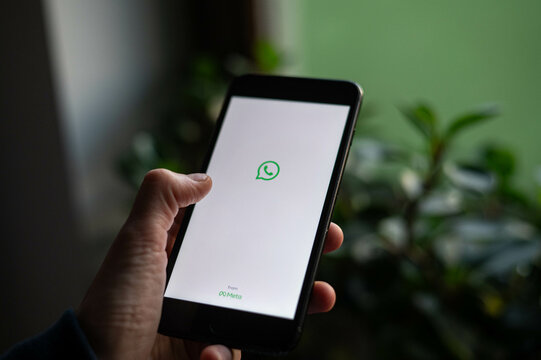 A person is opening WhatsApp app on a phone