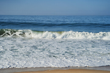 A closeup shot of the ocean with wind waves crashing onto the shore, creating a beautiful pattern...