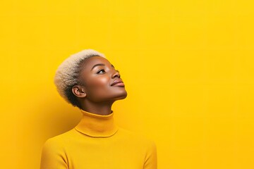Bright yellow backdrop enhances confident pose and expressive ga