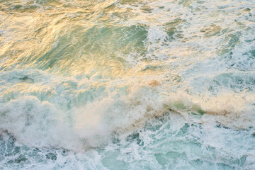 A closeup shot of the ocean with wind waves crashing onto the shore, creating a beautiful pattern...