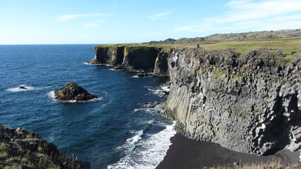 Dramatic coastal cliffs at Arnarstapi, Snæfellsnes Peninsula, Iceland, featuring striking basalt formations and ocean views.